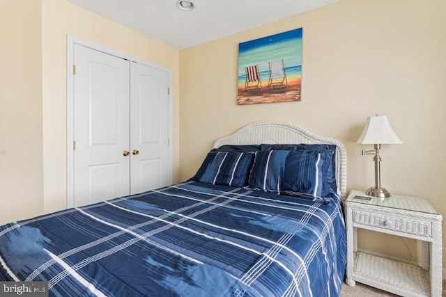 bedroom with carpet and a closet