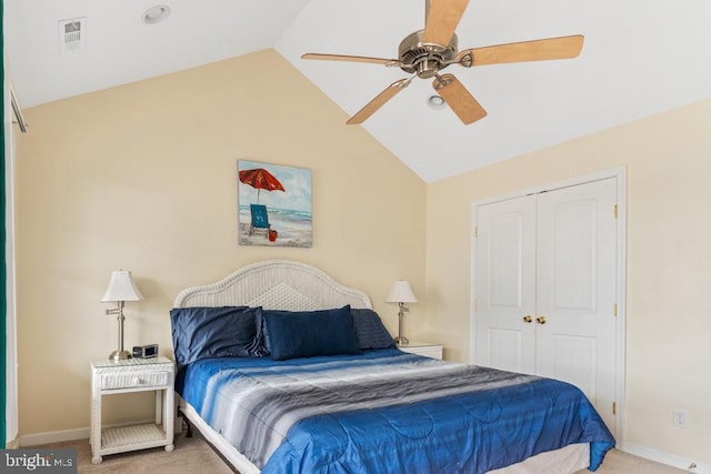 bedroom with lofted ceiling, a closet, ceiling fan, and carpet