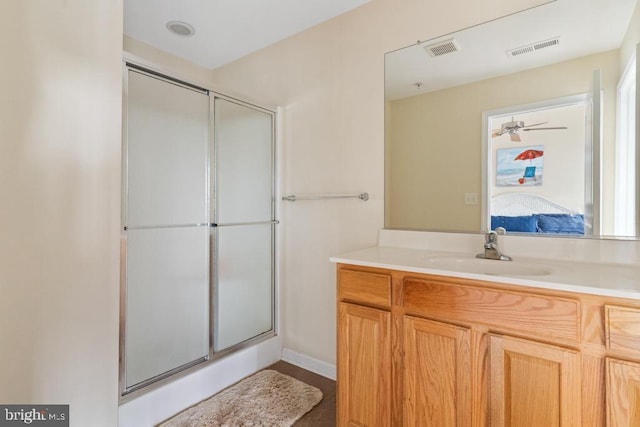 bathroom with walk in shower and vanity