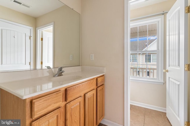 bathroom with tile patterned floors and vanity