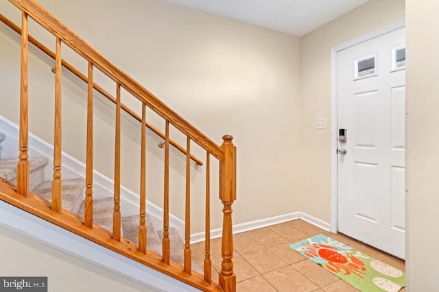 foyer entrance with light tile patterned floors