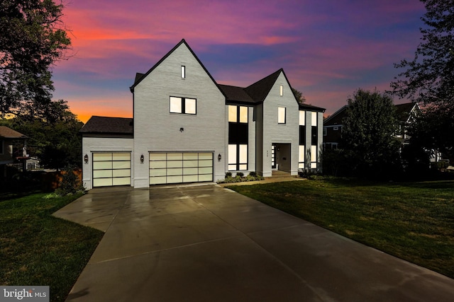 view of front facade with a garage and a lawn