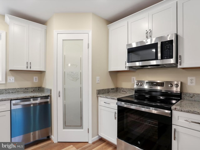 kitchen with white cabinetry and appliances with stainless steel finishes