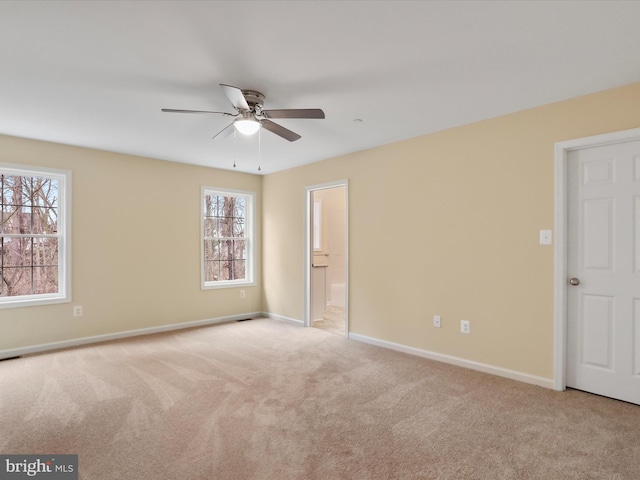 interior space featuring light carpet and ceiling fan