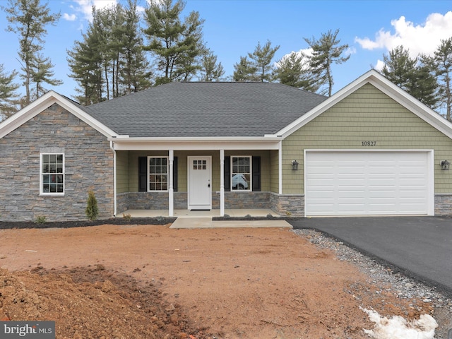 view of front of property with a garage and covered porch