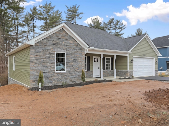 view of front of property with a garage and covered porch