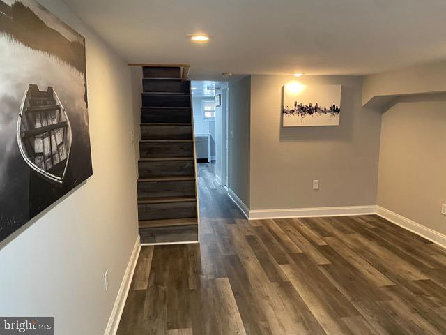 hallway with dark hardwood / wood-style flooring