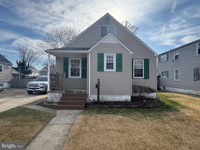 bungalow-style home with a front lawn