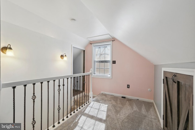 additional living space featuring lofted ceiling, light carpet, and baseboards