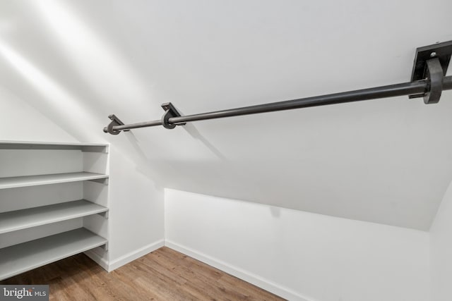 walk in closet featuring lofted ceiling and wood finished floors