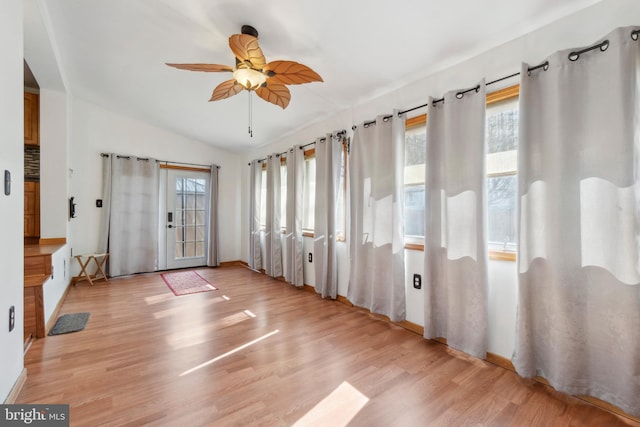 interior space with lofted ceiling, light wood-style flooring, and ceiling fan