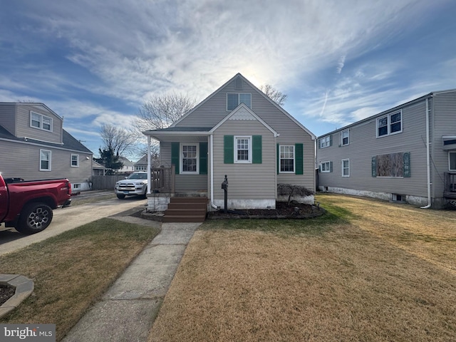 bungalow-style house featuring a front lawn