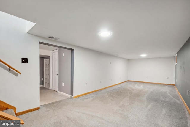 interior space featuring light carpet, baseboards, stairs, and visible vents