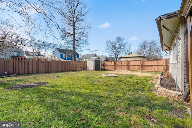 view of yard with a fenced backyard, an outdoor structure, and a shed