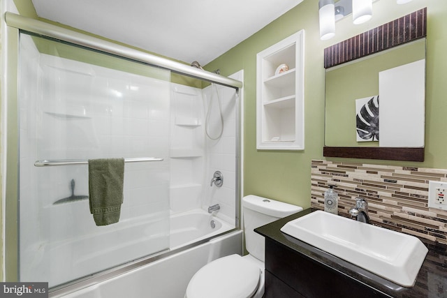 full bathroom featuring tasteful backsplash, vanity, toilet, and combined bath / shower with glass door