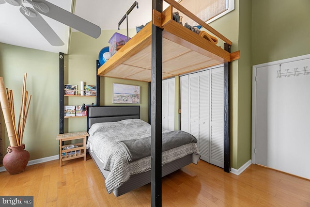 bedroom featuring light hardwood / wood-style floors and two closets