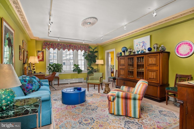 living room with ornamental molding, rail lighting, and a baseboard heating unit