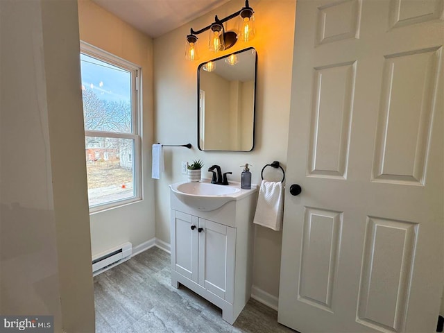 bathroom with a baseboard radiator, vanity, and hardwood / wood-style floors