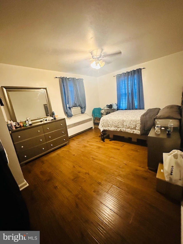 bedroom featuring dark wood-type flooring and ceiling fan