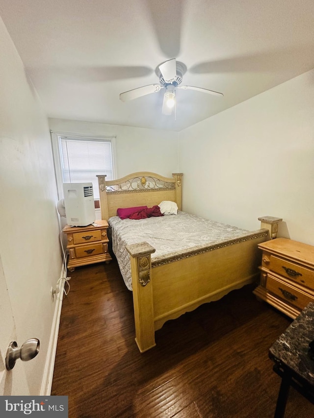 bedroom with dark hardwood / wood-style floors and ceiling fan