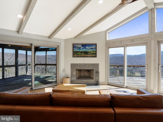 living room featuring a tile fireplace, a mountain view, and recessed lighting