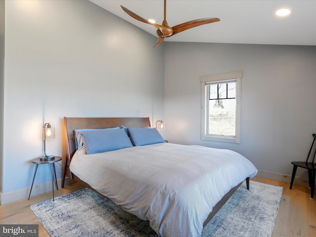 bedroom featuring light wood-type flooring, vaulted ceiling, baseboards, and recessed lighting