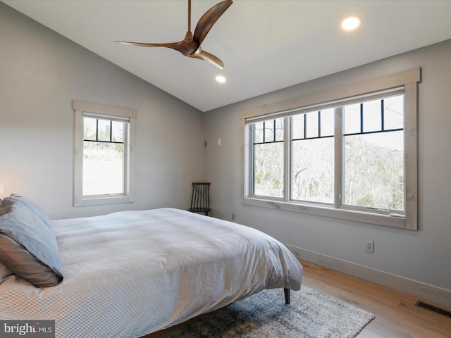 bedroom featuring recessed lighting, visible vents, vaulted ceiling, wood finished floors, and baseboards