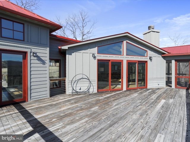 wooden deck featuring a sunroom