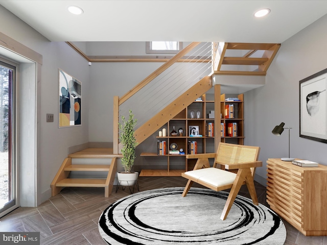 sitting room featuring recessed lighting and stairway