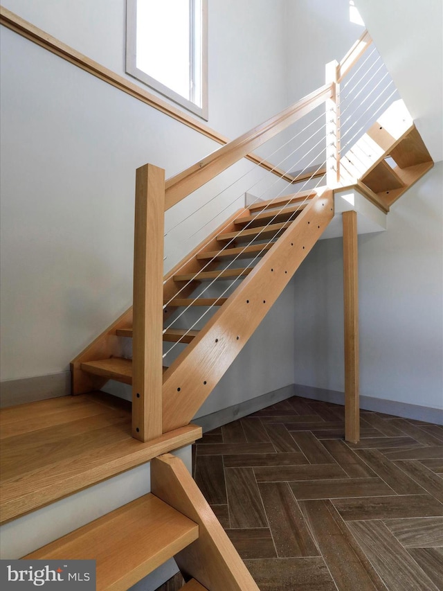 stairway featuring baseboards