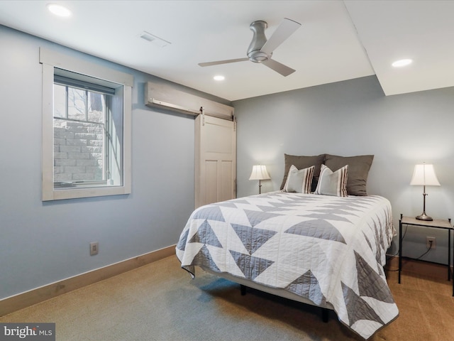 bedroom featuring a barn door, recessed lighting, carpet floors, visible vents, and baseboards