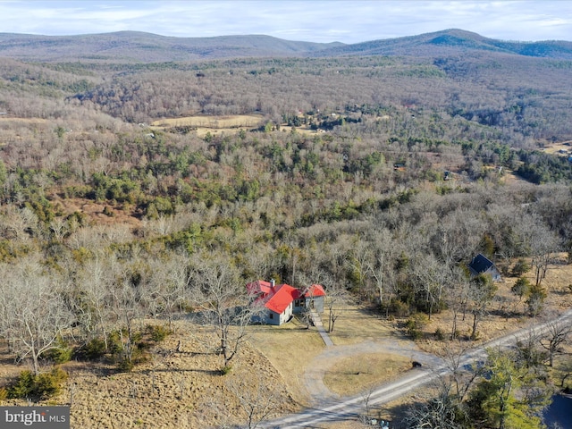 drone / aerial view featuring a forest view and a mountain view