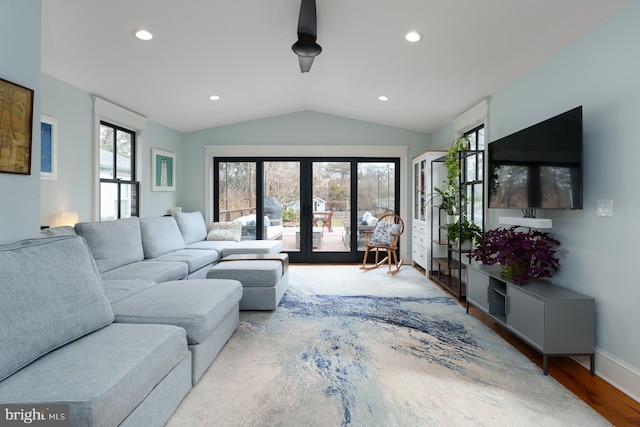 living area with french doors, lofted ceiling, recessed lighting, wood finished floors, and baseboards