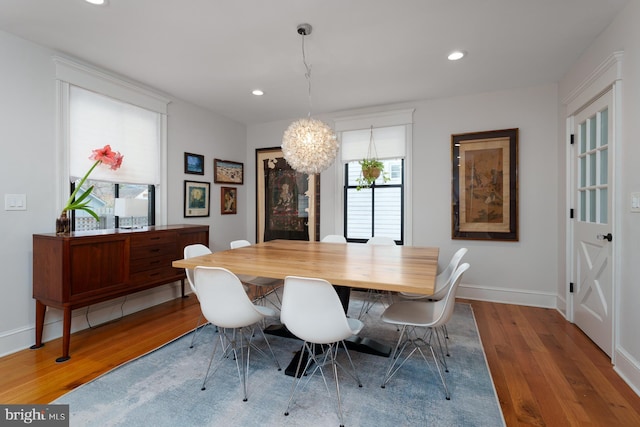 dining room with baseboards, a chandelier, wood finished floors, and recessed lighting