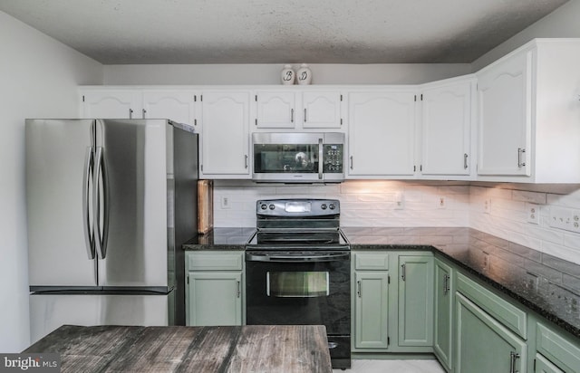 kitchen featuring white cabinetry, green cabinetry, and appliances with stainless steel finishes