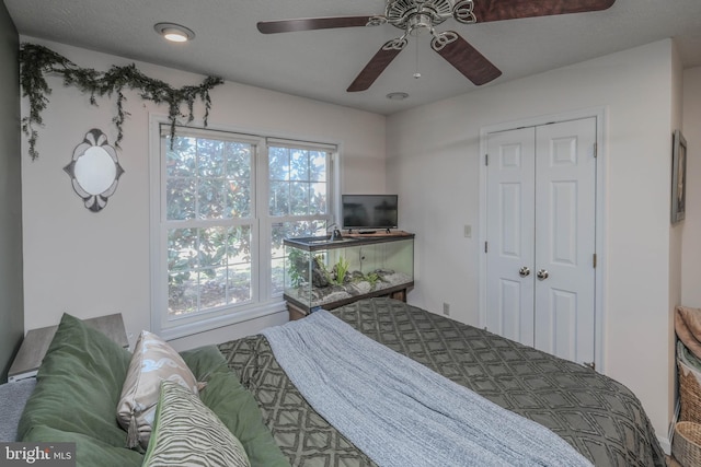 bedroom with ceiling fan and a closet