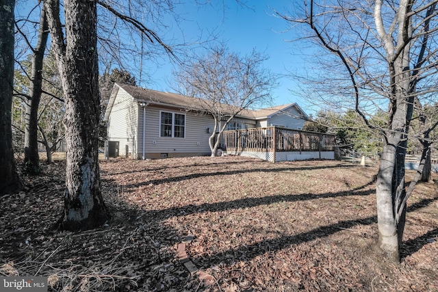 back of house featuring central AC unit and a deck