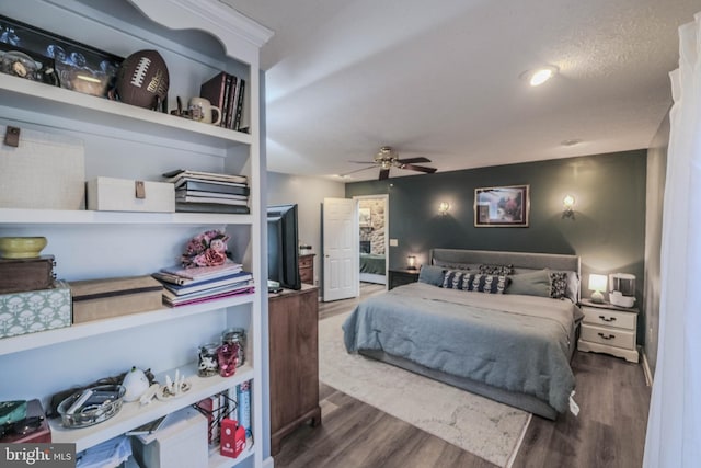 bedroom with dark wood-type flooring and ceiling fan