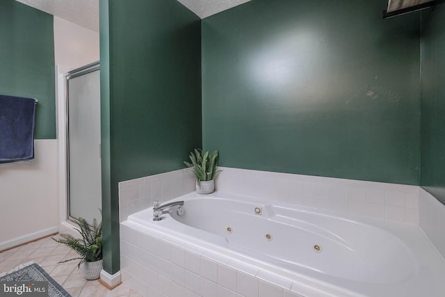 bathroom with independent shower and bath and tile patterned flooring