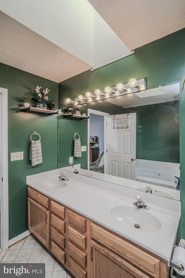 bathroom with vanity, tile patterned flooring, and a textured ceiling