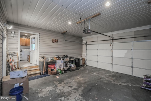 garage featuring washer / clothes dryer and a garage door opener