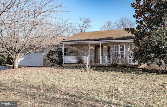 single story home with a garage, a front lawn, and a porch