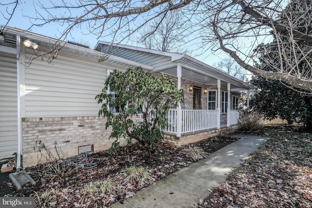 view of property exterior featuring a porch