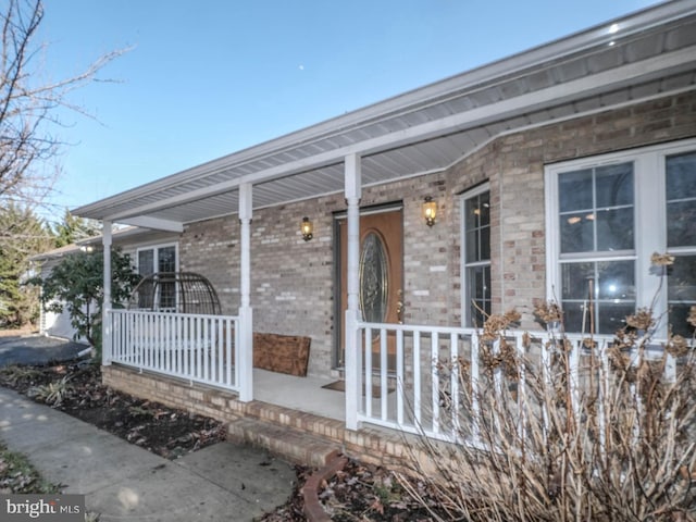 view of exterior entry with covered porch