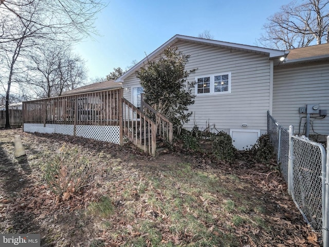 rear view of house featuring a deck