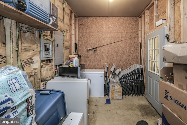 laundry room with electric panel and washer and clothes dryer