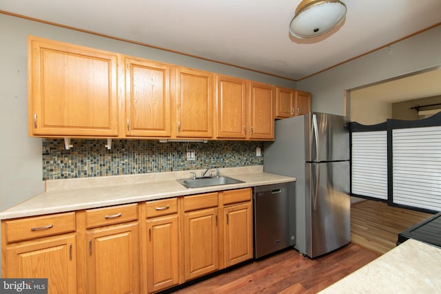 kitchen featuring tasteful backsplash, sink, dark wood-type flooring, and appliances with stainless steel finishes