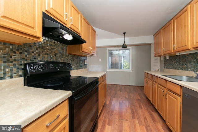 kitchen with hardwood / wood-style floors, sink, backsplash, hanging light fixtures, and black appliances