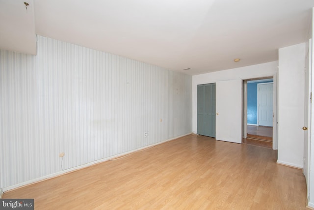 empty room with light hardwood / wood-style flooring