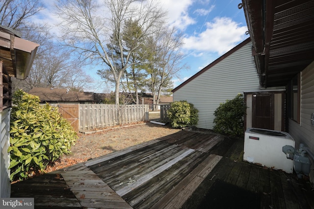 wooden deck featuring cooling unit